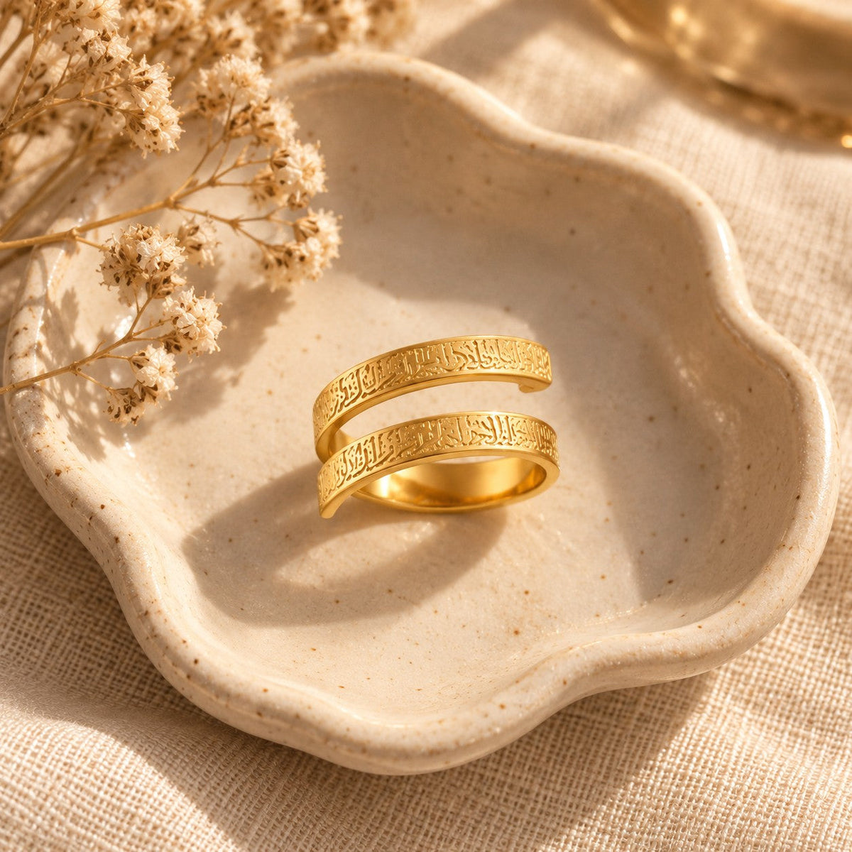The Ayatul Kursi Spiral Ring in a ceramic trinket dish